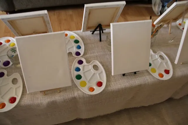 Rainbow party ideas: set up easels with rainbow paint trays