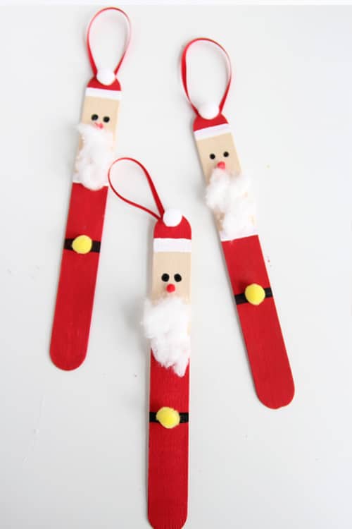 See how to make these adorable popsicle stick Santa ornaments. These are simple to make and super fun for an ornament party and crafting with the kids at home.