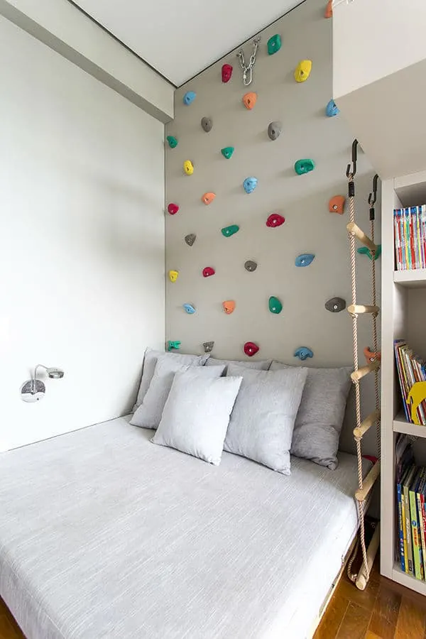 Make a climbing wall over kids bed for an easy indoor climbing area. The bed keeps landings soft! via Triplex