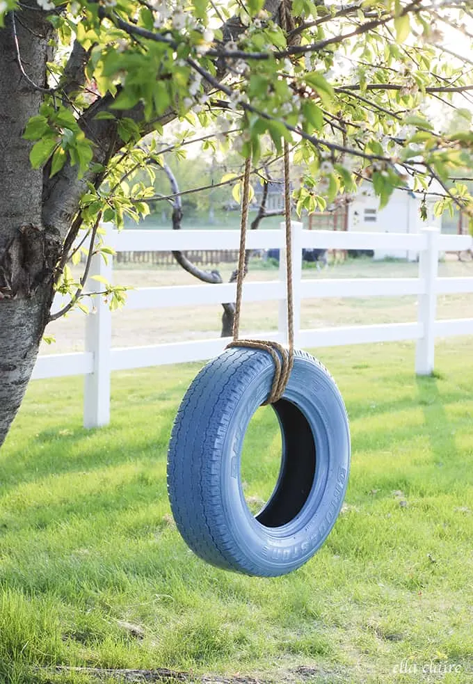 Learn how to hang a tire swing (via Claire Inspired) to add some charm to your kids backyard play space. A ton of awesome DIY backyard play area ideas. 