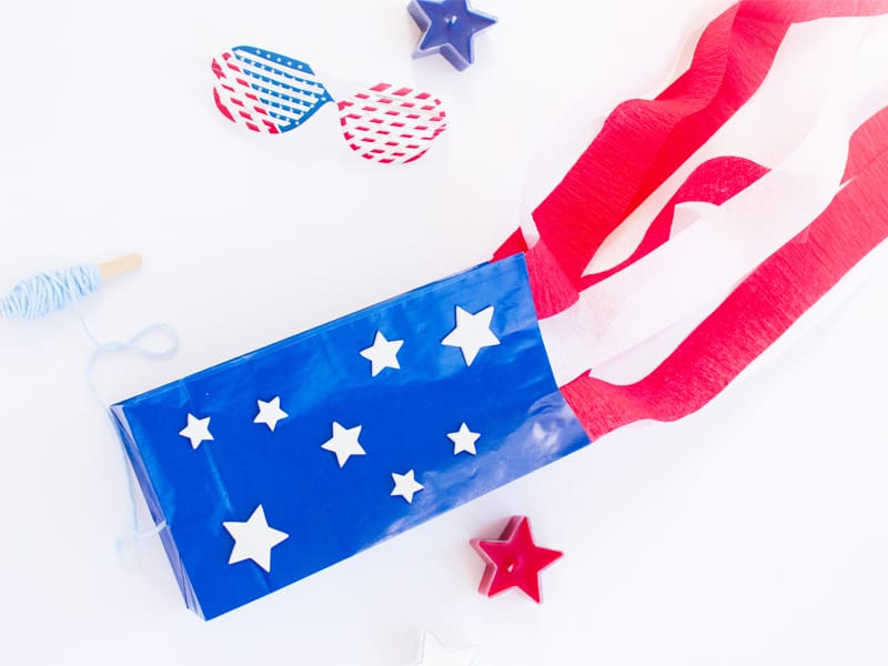 Make a paper bag kite with stars and stripes like the American Flag. Fun patriotic craft for kids.