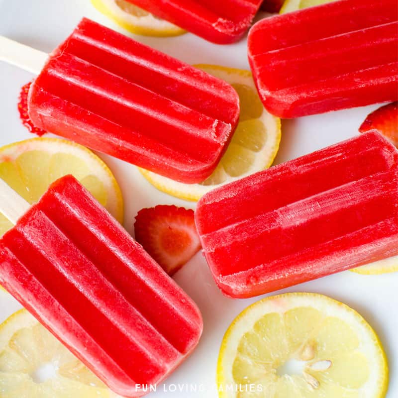 Homemade fresh fruit popsicles with strawberries and lemons.
