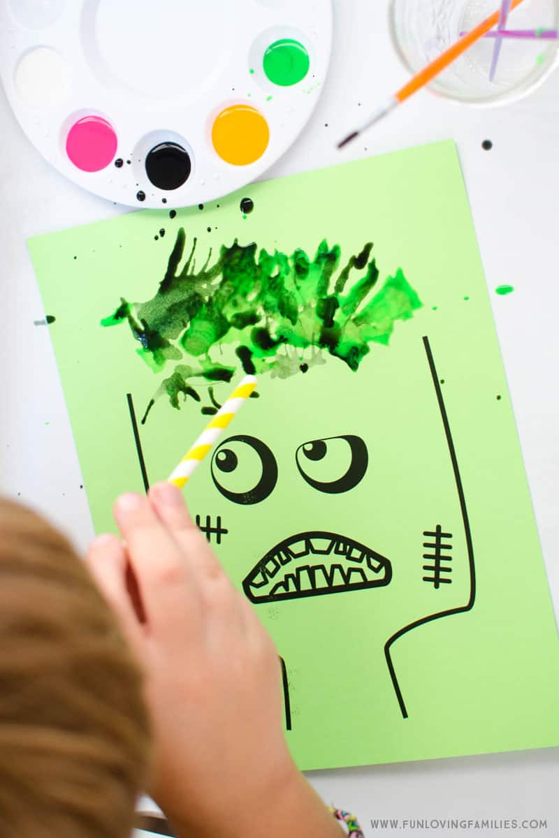 We used the zombie printable and had a blast doing blow painting with straws. Add paint all over the zombie's hair to make fun and crazy hairstyles! #kidsartproject #kidsart #kidsartactivity #zombiecraft #kidsactivity #freeprintable #funlovingfamilies