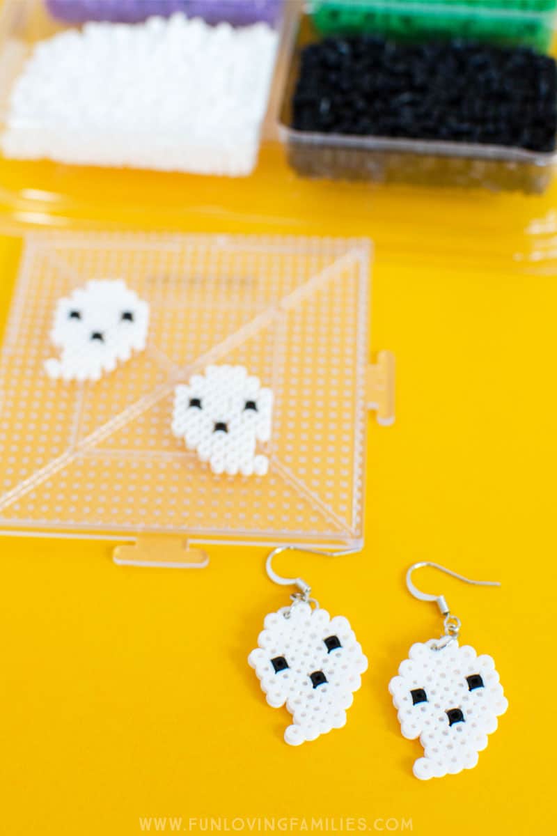 These cute little DIY ghost earrings are perfect for Halloween! #halloweenDIY #perlerbeads #fusebeads #fusebeadcrafts #perlerbeadcrafts #meltybeadcrafts #halloweencraft #halloweenjewely #tweencrafts #teencrafts #funlovingfamilies