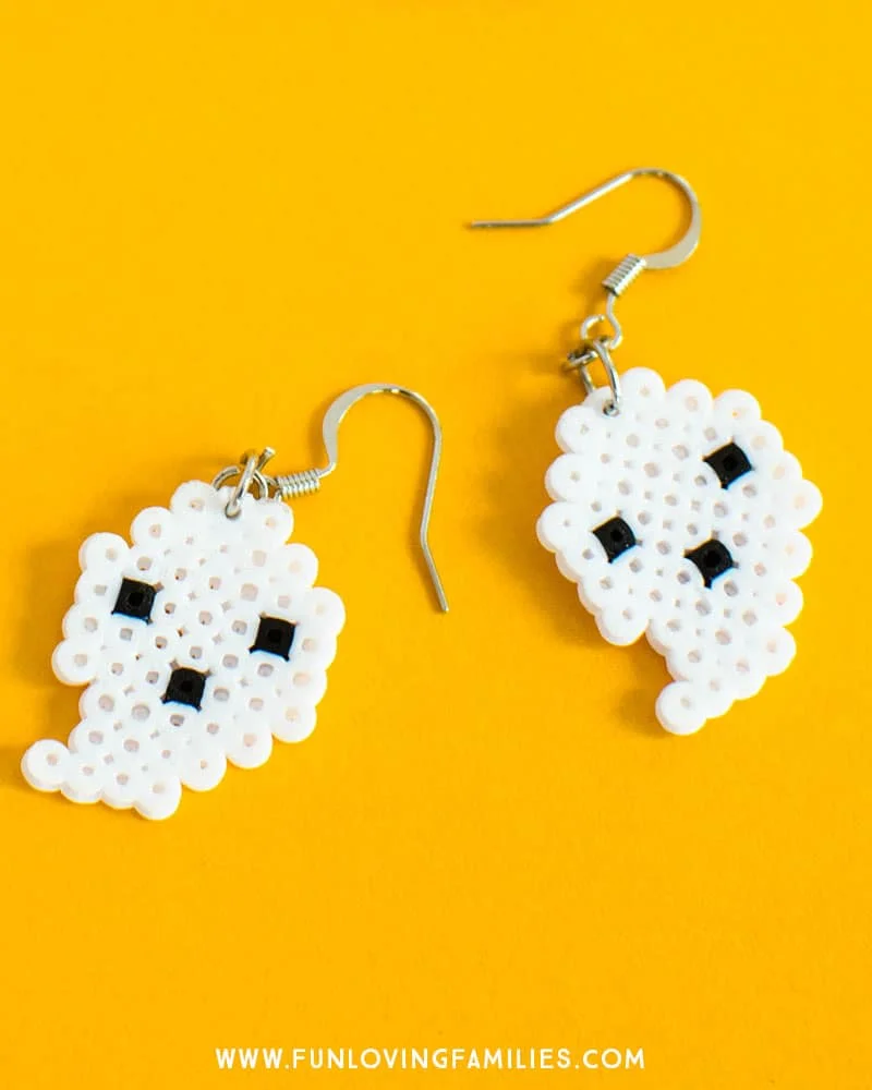 Cute DIY Halloween Perler Bead earrings. So fun, so cute, and so easy to make. Great Halloween craft for tweens or teens. #halloween #halloweencraft #halloweenDIY #halloweenearrings #halloweenperlerbeads #perlerbeads #perlerbeadearrings #funlovingfamilies