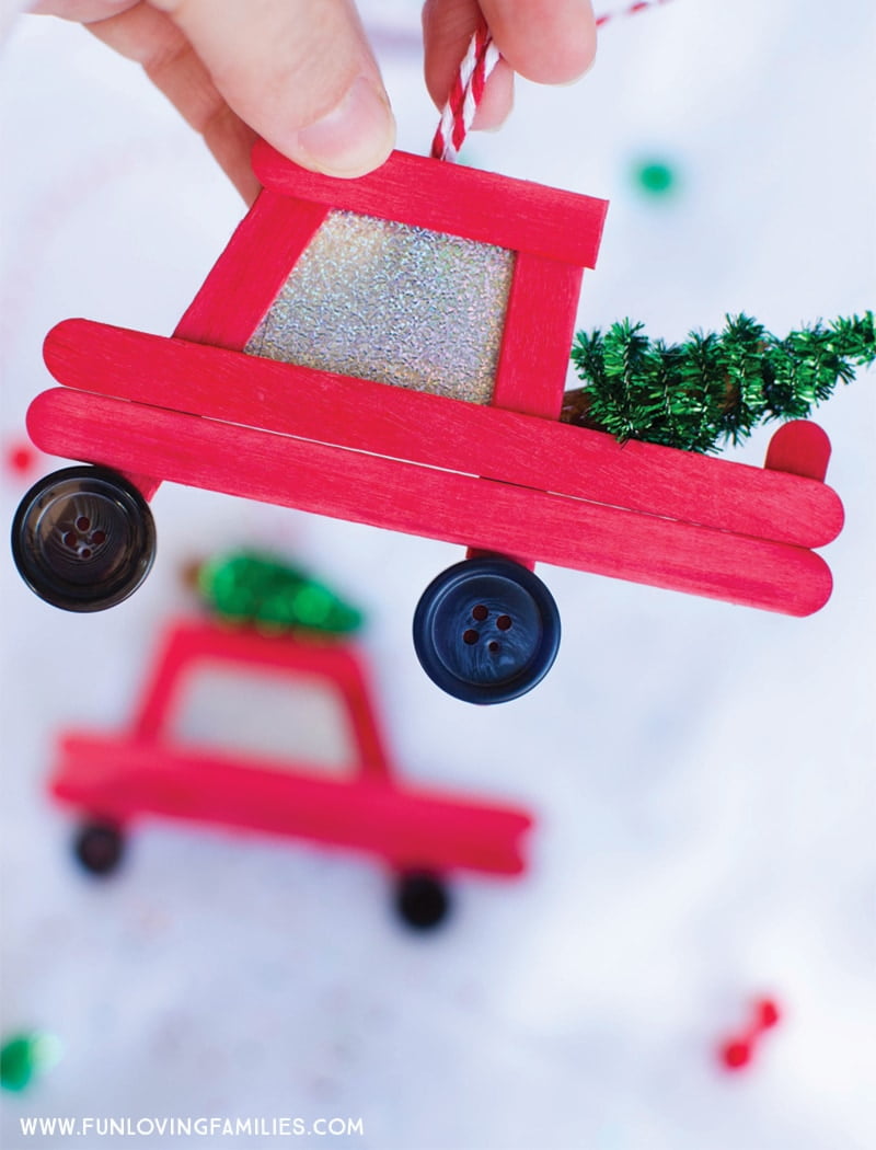 DIY popsicle stick Christmas ornaments: How cute are these little red car and truck DIY ornaments! Click through for the easy step-by-step tutorial. #Christmas #Christmasornaments #DIYchristmasornaments #handmadeornaments #farmtruckornament #christmastreecarornament #christmascar #christmastruck #christmascrafts #popsiclestickornaments