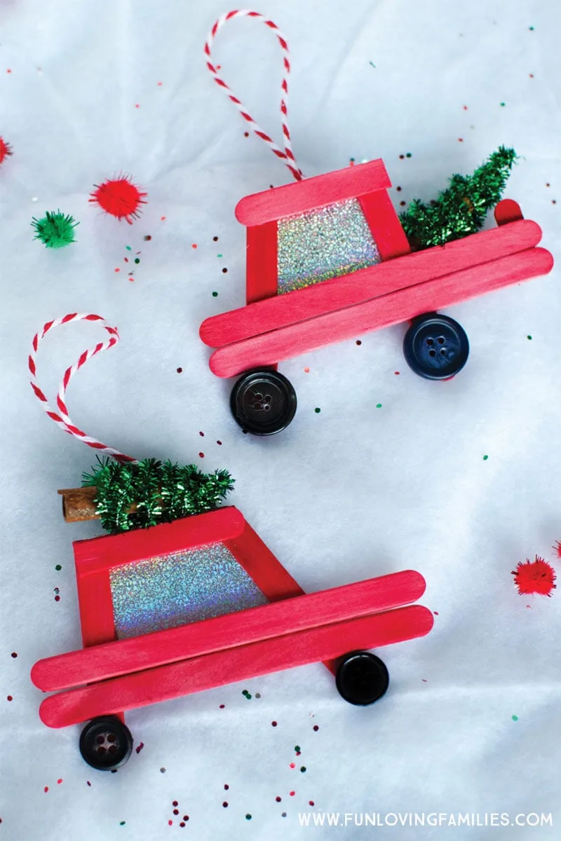DIY popsicle stick Christmas ornaments: How cute are these little red car and truck DIY ornaments! Click through for the easy step-by-step tutorial. #Christmas #Christmasornaments #DIYchristmasornaments #handmadeornaments #farmtruckornament #christmastreecarornament #christmascar #christmastruck #christmascrafts #popsiclestickornaments