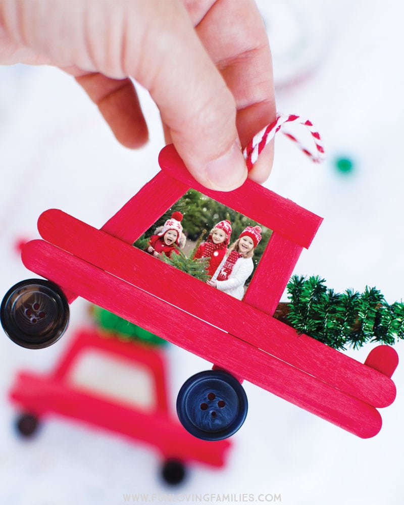Make this adorable DIY popsicle stick Christmas truck and add a special holiday photo. Fun Christmas craft and family keepsake ornament. #christmas #diychristmasornaments #handmadeornament #popsiclestickornament #christmascrafts #funlovingfamilies