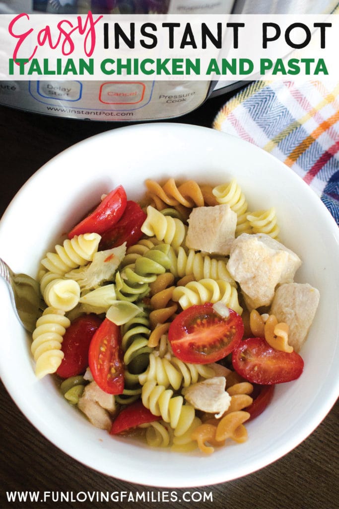 White bowl with tri-color rotini, tomatoes, and chicken