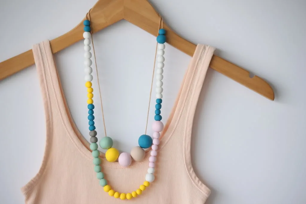 colorful clay bead necklaces and peach tank top