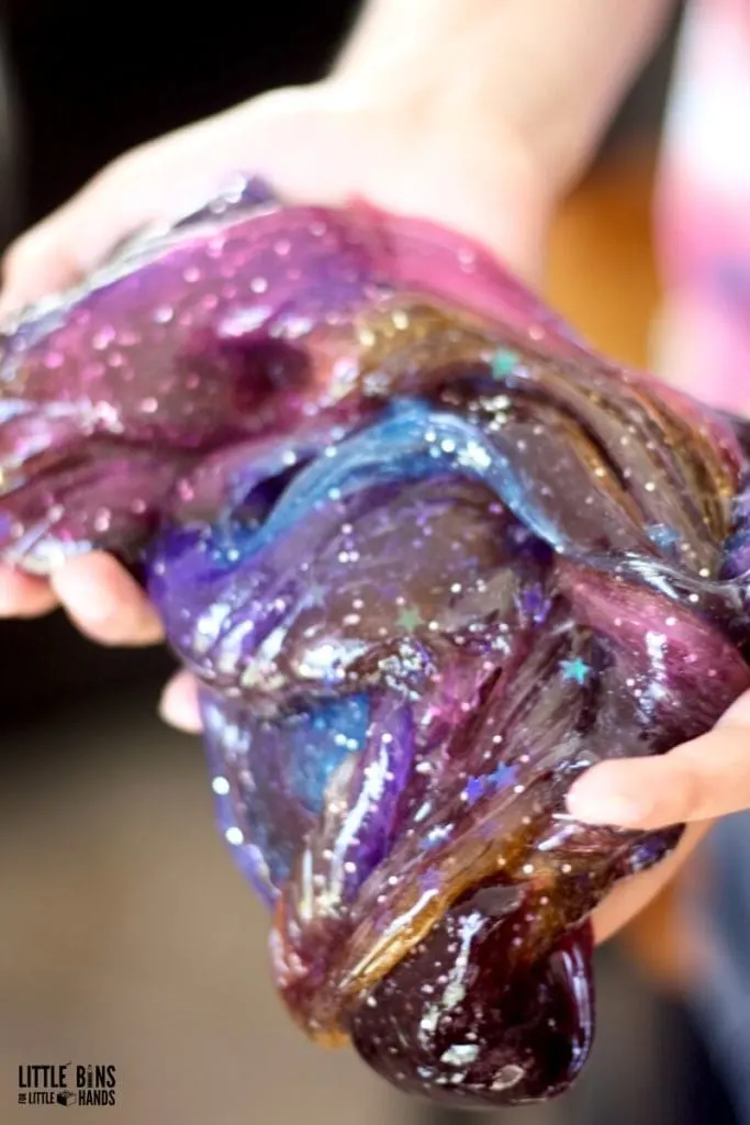 person holding homemade galaxy slime