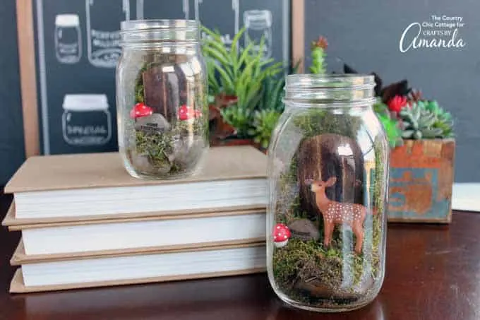 mason jar terrarium fairy gardens with deer and toadstool.
