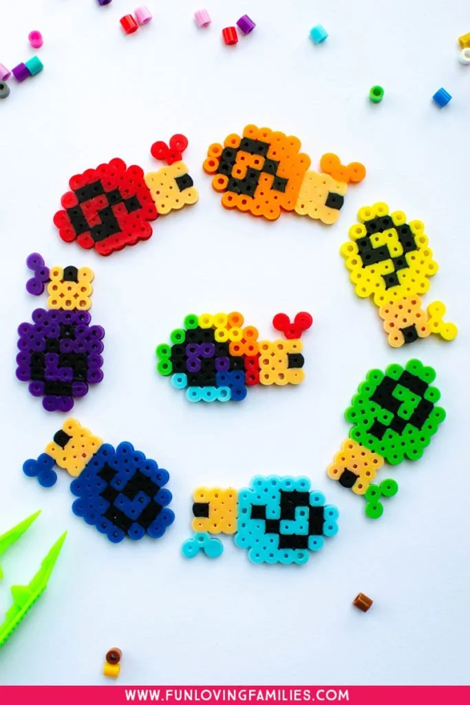 Perler bead craft snails in rainbow colors