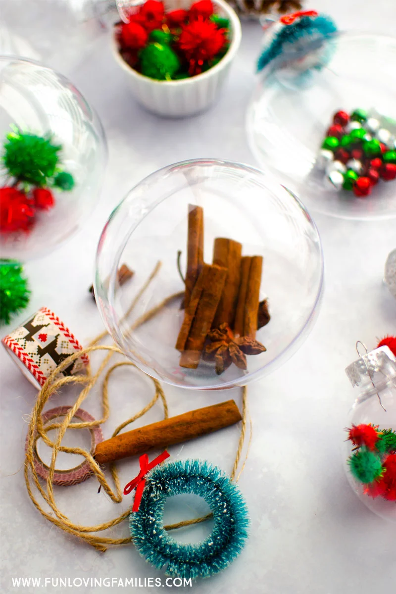 clear Christmas ornaments filled with colorful crafting supplies