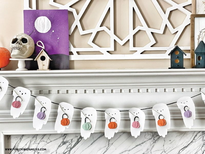 halloween handprint craft ghost bunting on mantel with colorful origami pumpkins