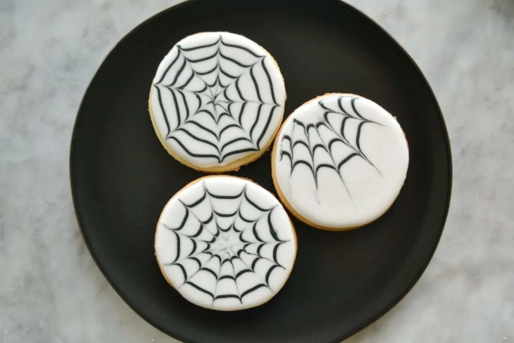plate with iced spider web sugar cookies