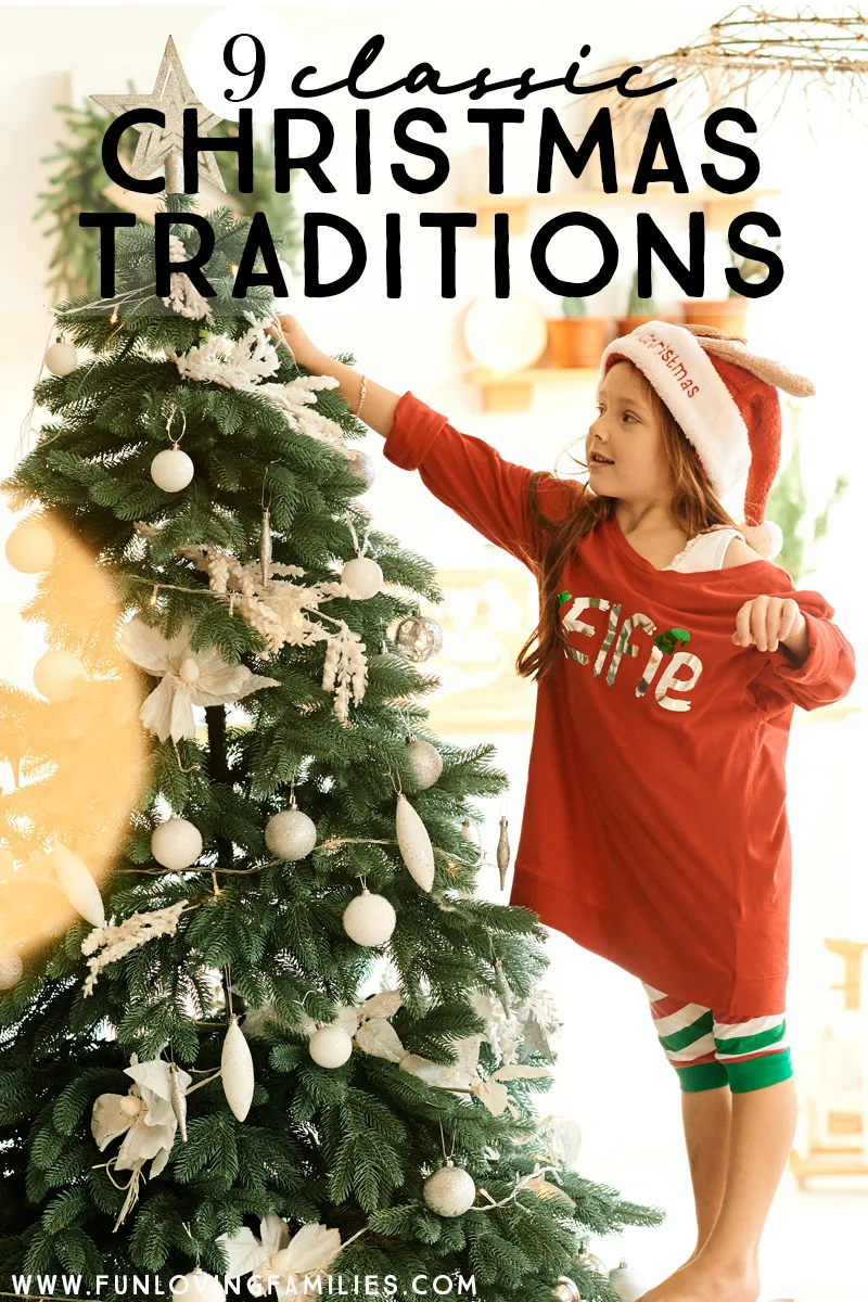 girl adding ornaments to Christmas tree