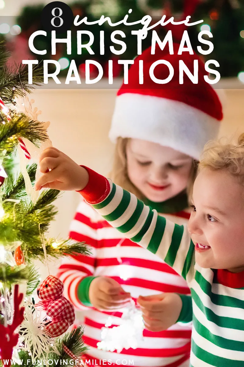 kids in Christmas pajamas adding ornament to tree