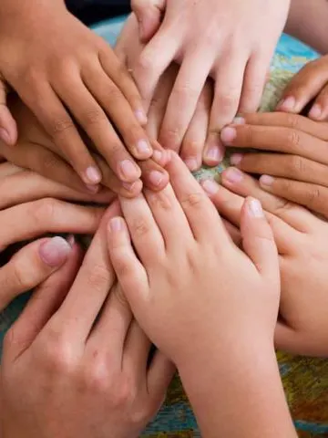 diversity kids hands together on globe