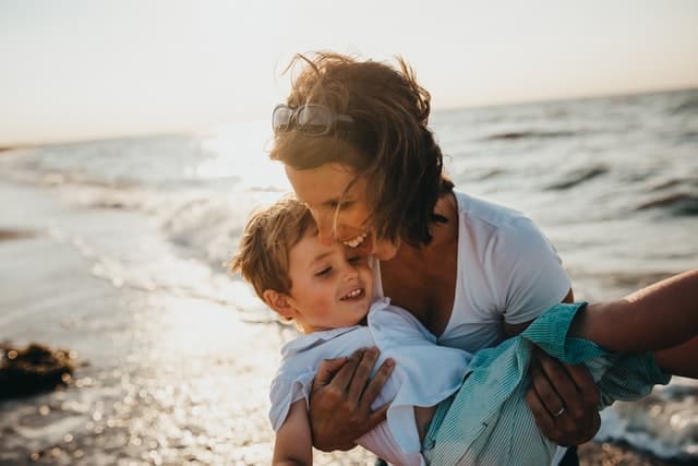 Mom on the beach with a kid